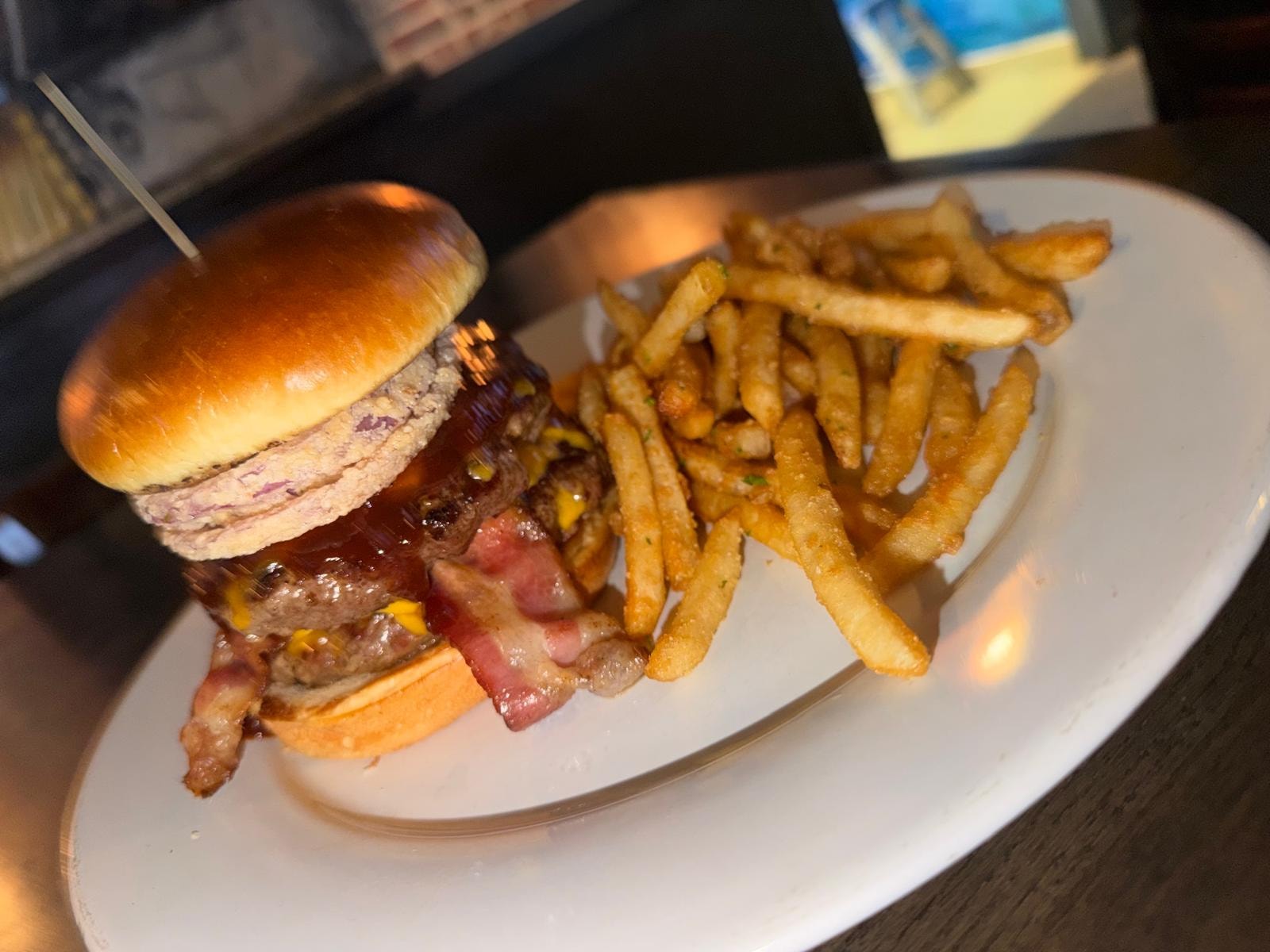 Bacon cheeseburger with crispy fries close-up at Westrail