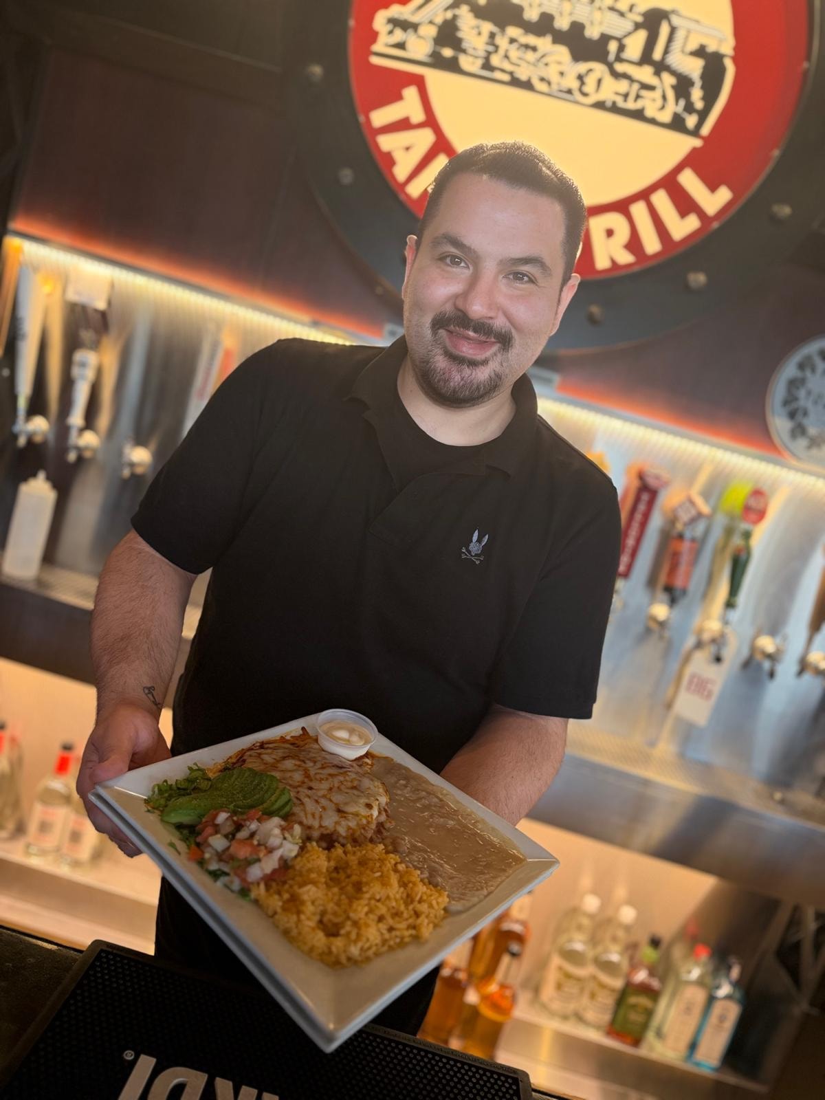 Chef presenting a plated dish at Westrail Tap and Tequila