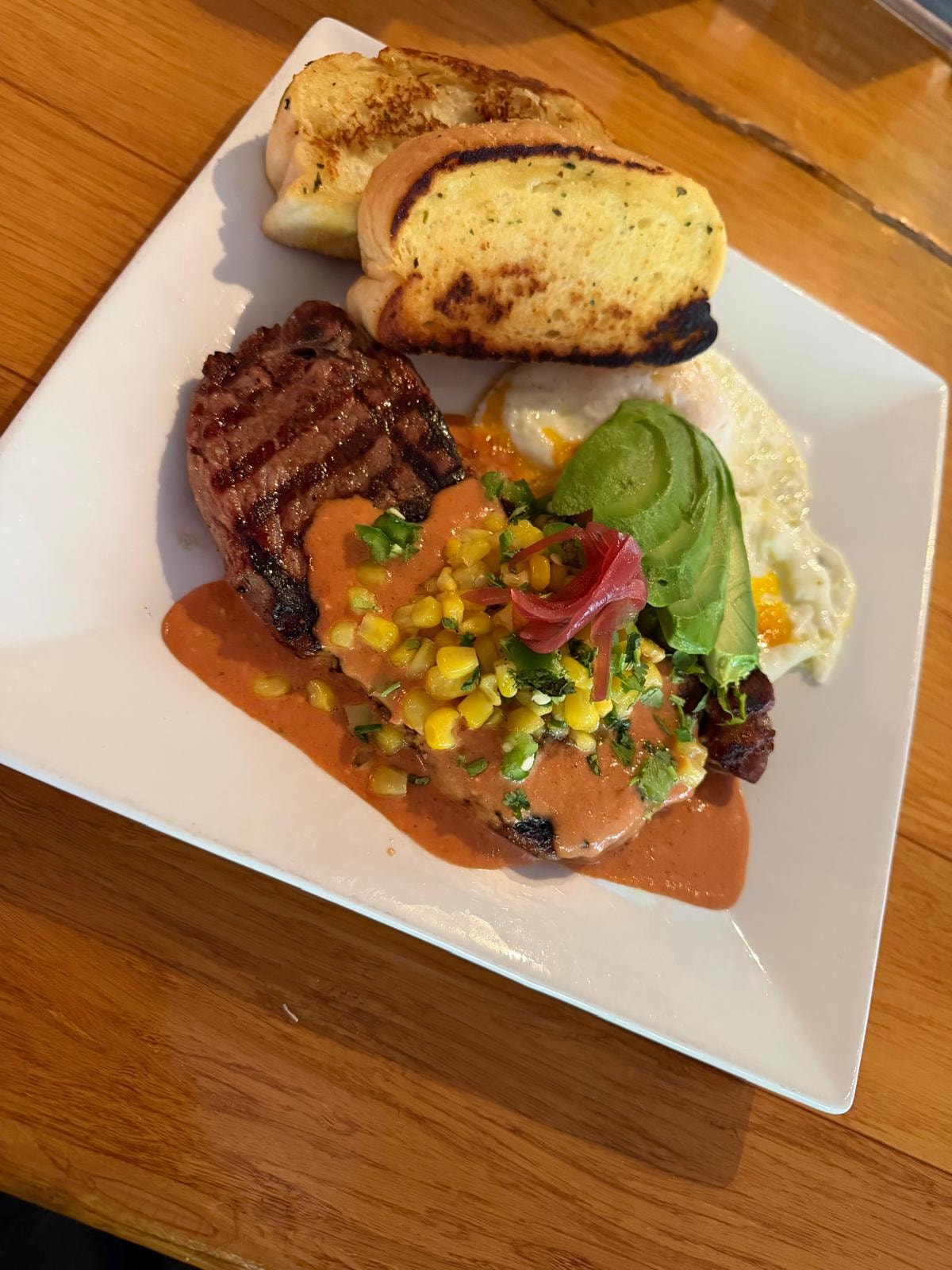 Brunch steak with avocado corn salsa and garlic toast at Westrail