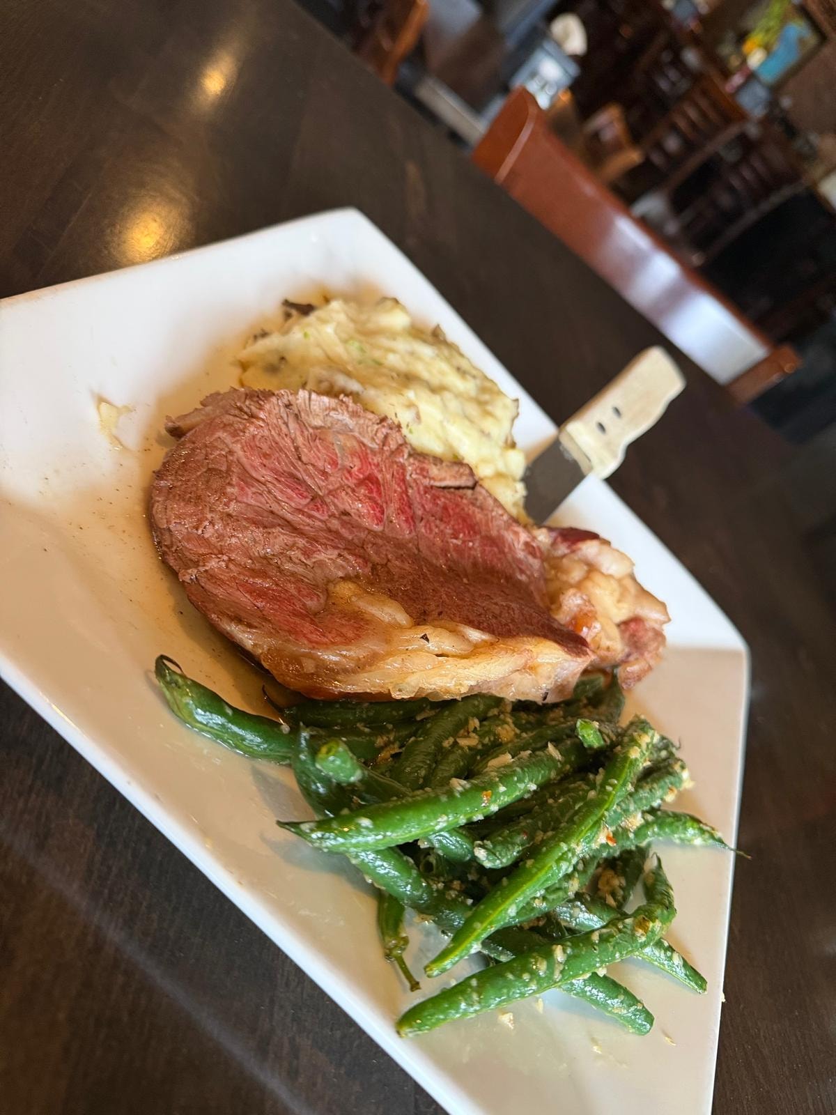 Sliced steak with mashed potatoes and green beans at Westrail